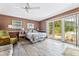 Spacious main bedroom with a ceiling fan, and sliding glass doors leading to an outdoor patio at 4650 Saxon Dr, New Smyrna Beach, FL 32169