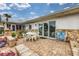 Outdoor patio featuring brick pavers, seating, and sliding glass doors leading indoors at 4650 Saxon Dr, New Smyrna Beach, FL 32169