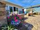 Private patio with brick pavers and colorful plants at 4650 Saxon Dr, New Smyrna Beach, FL 32169