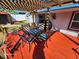 Relaxing pergola-covered deck with seating for four at 4650 Saxon Dr, New Smyrna Beach, FL 32169