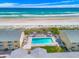 Breathtaking aerial view showcasing a beachside complex with a sparkling pool and direct beach access at 4773 S Atlantic Ave # 10, Ponce Inlet, FL 32127