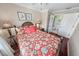 Bright bedroom with floral bedding and ensuite bathroom access at 4773 S Atlantic Ave # 10, Ponce Inlet, FL 32127