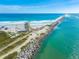 Aerial view of a jetty extending into the ocean, featuring a lifeguard tower at 4773 S Atlantic Ave # 10, Ponce Inlet, FL 32127