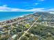 Aerial view showcasing home's proximity to the ocean at 50 Pompano Dr, Ponce Inlet, FL 32127