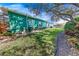 Spacious backyard with grassy area and privacy hedge at 50 Pompano Dr, Ponce Inlet, FL 32127