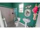 Small bathroom with shower, toilet and pedestal sink at 50 Pompano Dr, Ponce Inlet, FL 32127