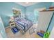 Bright bedroom with a striped bedspread and built-in wardrobe at 50 Pompano Dr, Ponce Inlet, FL 32127