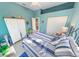 Bedroom with a blue and white themed bedspread and built-in wardrobe at 50 Pompano Dr, Ponce Inlet, FL 32127