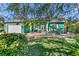 Charming teal home with landscaped yard and attached garage at 50 Pompano Dr, Ponce Inlet, FL 32127