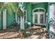 Inviting front porch with seating area and etched glass door at 50 Pompano Dr, Ponce Inlet, FL 32127