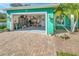 Organized garage with ample storage space and paved driveway at 50 Pompano Dr, Ponce Inlet, FL 32127