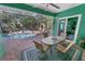 Covered patio with dining area and view of refreshing pool at 50 Pompano Dr, Ponce Inlet, FL 32127