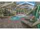 Relaxing screened pool area with lounge chairs and brick pavers at 50 Pompano Dr, Ponce Inlet, FL 32127