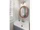 Simple bathroom with a vanity and oval mirror at 504 N Riverside Dr, New Smyrna Beach, FL 32168