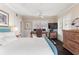 Serene bedroom with a teal bed frame, and a home office at 504 N Riverside Dr, New Smyrna Beach, FL 32168