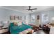 Spacious bedroom with teal bedding, and access to a private balcony at 504 N Riverside Dr, New Smyrna Beach, FL 32168