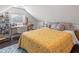 Cozy attic bedroom with yellow bedding and a workspace at 504 N Riverside Dr, New Smyrna Beach, FL 32168