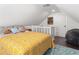 Upstairs bedroom with yellow bedding, and a view of the home's exterior at 504 N Riverside Dr, New Smyrna Beach, FL 32168