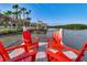 Relaxing dock with red chairs and views of the water at 504 N Riverside Dr, New Smyrna Beach, FL 32168