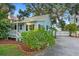 Quaint cottage with a front porch and landscaped yard at 504 N Riverside Dr, New Smyrna Beach, FL 32168