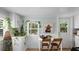 Cozy kitchen with white cabinets and a farmhouse-style table at 504 N Riverside Dr, New Smyrna Beach, FL 32168