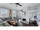 Living room with whitewashed fireplace, built-in shelves, and sectional sofa at 504 N Riverside Dr, New Smyrna Beach, FL 32168