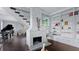 Living room with whitewashed fireplace, built-in shelves, and hardwood floors at 504 N Riverside Dr, New Smyrna Beach, FL 32168