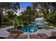 Inviting freeform pool and spa surrounded by lush landscaping at 504 N Riverside Dr, New Smyrna Beach, FL 32168