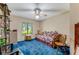 Guest bedroom with daybed, blue carpet, and built-in shelving at 507 Boxwood Ln, New Smyrna Beach, FL 32168