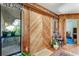 Entryway with wood paneled walls and unique wood doors at 507 Boxwood Ln, New Smyrna Beach, FL 32168