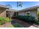 Brick and wood exterior entryway with lush landscaping at 507 Boxwood Ln, New Smyrna Beach, FL 32168