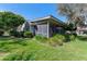 Rear view of home with screened porch and lush landscaping at 507 Boxwood Ln, New Smyrna Beach, FL 32168