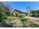 Side view of brick ranch home showcasing a well-manicured lawn at 507 Boxwood Ln, New Smyrna Beach, FL 32168