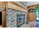 Rustic brick fireplace with wood mantel and glass doors at 507 Boxwood Ln, New Smyrna Beach, FL 32168