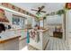 White kitchen with island, view of breakfast nook and back door at 507 Boxwood Ln, New Smyrna Beach, FL 32168