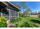 Peaceful screened porch overlooking a lush green golf course at 507 Boxwood Ln, New Smyrna Beach, FL 32168