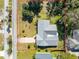 Aerial view of a single-story home with a grey roof and landscaped yard at 51 Club House Blvd, New Smyrna Beach, FL 32168