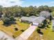 Aerial view of single-story home with large yard and driveway at 51 Club House Blvd, New Smyrna Beach, FL 32168