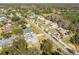 An aerial view of a house with a grey roof in a residential neighborhood at 51 Club House Blvd, New Smyrna Beach, FL 32168