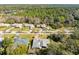 Aerial view of a single story home with grey roof, surrounded by trees at 51 Club House Blvd, New Smyrna Beach, FL 32168