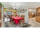 Elegant dining room with a red tablecloth and access to kitchen and living room at 51 Club House Blvd, New Smyrna Beach, FL 32168