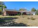 Brick ranch home exterior showcasing landscaping and a spacious yard at 51 Club House Blvd, New Smyrna Beach, FL 32168