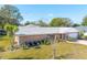 Brick ranch home with mature landscaping and a large backyard at 51 Club House Blvd, New Smyrna Beach, FL 32168