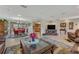 Bright living room featuring leather furniture and a large TV at 51 Club House Blvd, New Smyrna Beach, FL 32168