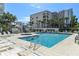 Inviting pool area with lounge chairs and a hot tub at 5207 S Atlantic Ave # 626, New Smyrna Beach, FL 32169