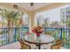 Private balcony with table and chairs, and a view of palm trees at 5300 S Atlantic Ave # 15-201, New Smyrna Beach, FL 32169