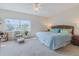 Spacious bedroom with a king-size bed and sitting area at 5300 S Atlantic Ave # 15-201, New Smyrna Beach, FL 32169