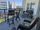 Cozy balcony featuring comfortable seating and a high-top table, perfect for enjoying the views of the building and the city skyline at 5300 S Atlantic Ave # 3-504, New Smyrna Beach, FL 32169