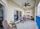 Spacious outdoor balcony furnished with chairs, a table, and a fan, creating a relaxing space for entertaining at 5300 S Atlantic Ave # 3-504, New Smyrna Beach, FL 32169