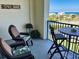 Relaxing balcony with chairs, a table, and ocean views, perfect for outdoor lounging at 5300 S Atlantic Ave # 3-504, New Smyrna Beach, FL 32169
